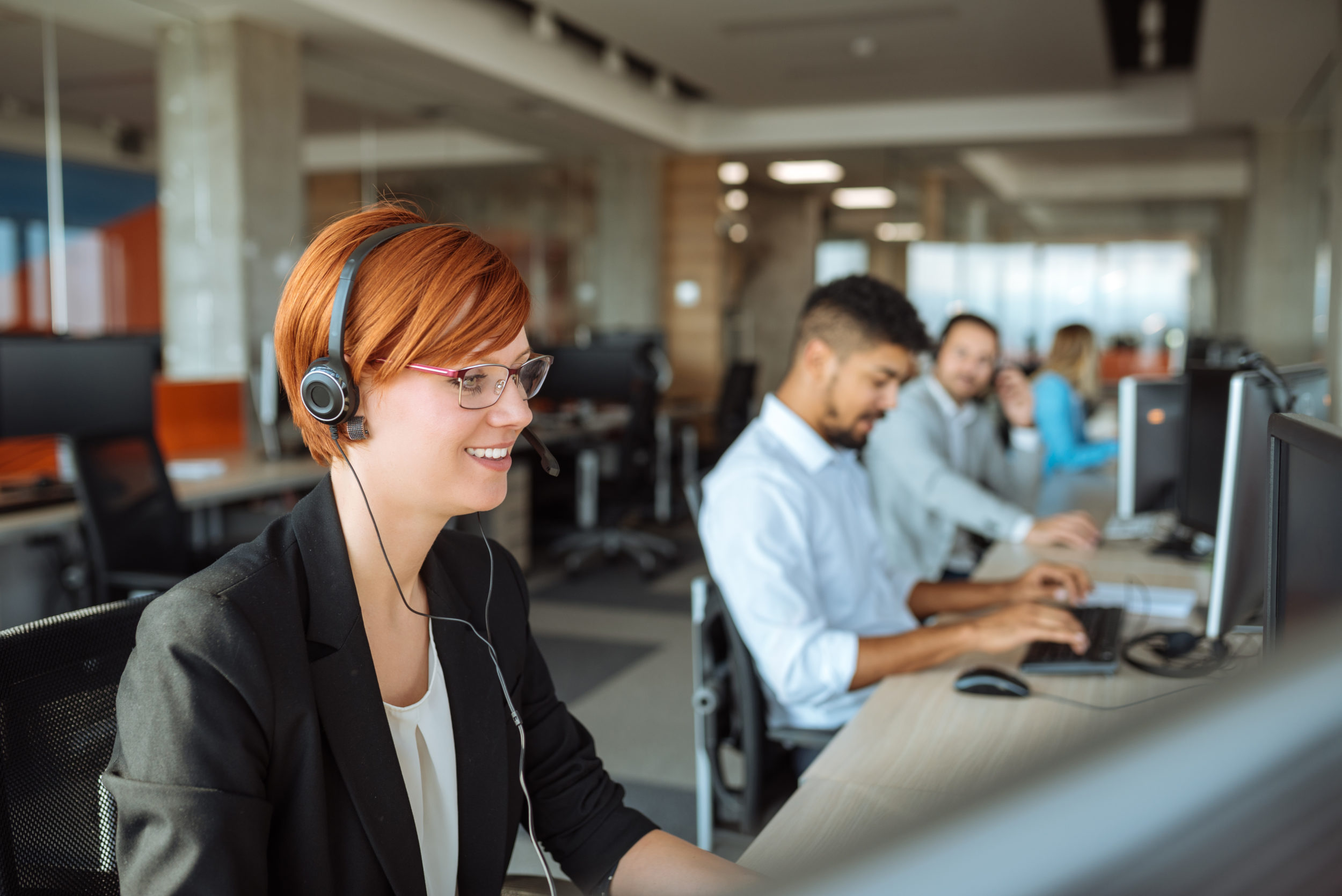 Photo of a successful dispatcher working on a computer in the office